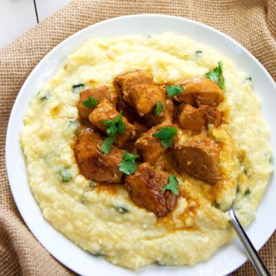 Spicy Sriracha Chicken over Goat Cheese & Roasted Poblano Grits